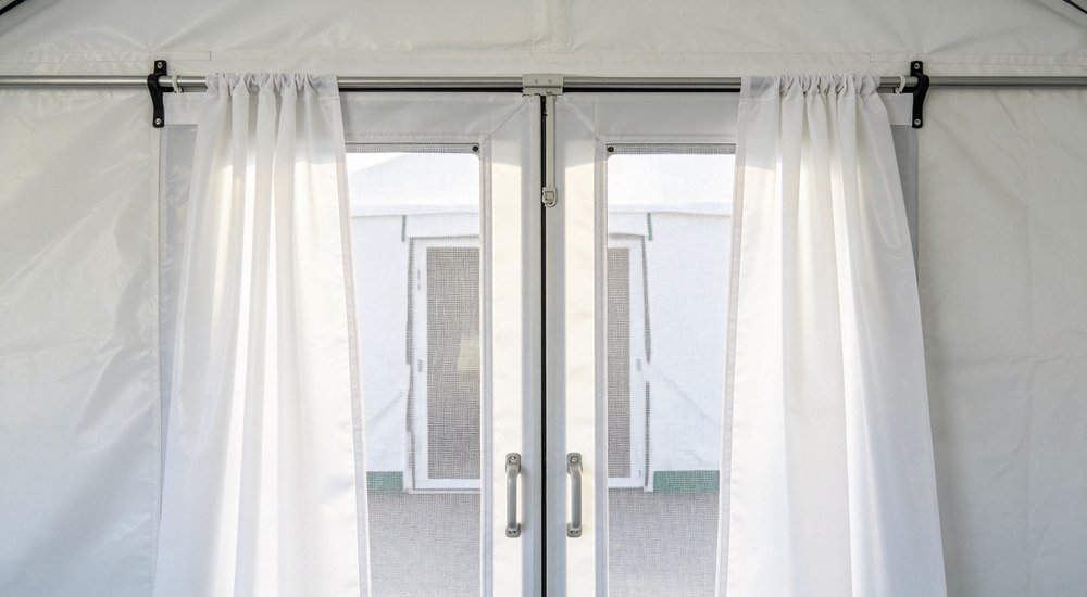 Door curtain on inflatable medical tent entrance, fabric partition, close-up detail red and white inflatable emergency shelter for disaster relief operations