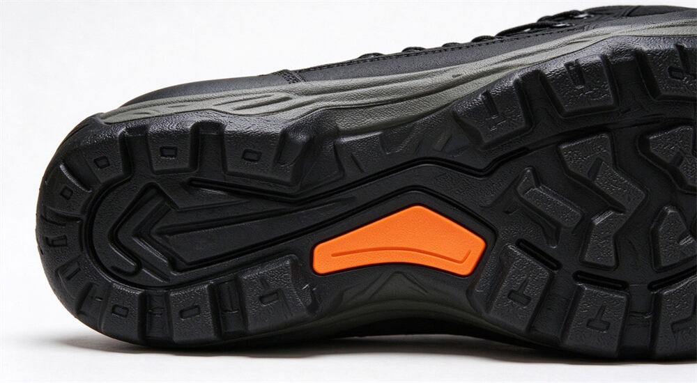 Molded non slip rubber outsole tread pattern close up, deep self cleaning lugs for mud and boat deck, flood rescue boots sole design detail