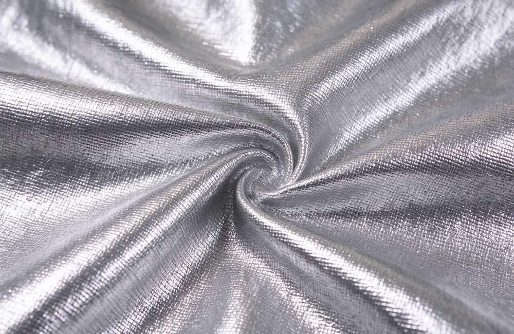 Detail view view of aluminized fabric reflective surface on fire proximity suit for radiant heat blocking technology detail and high temperature garment quality inspection